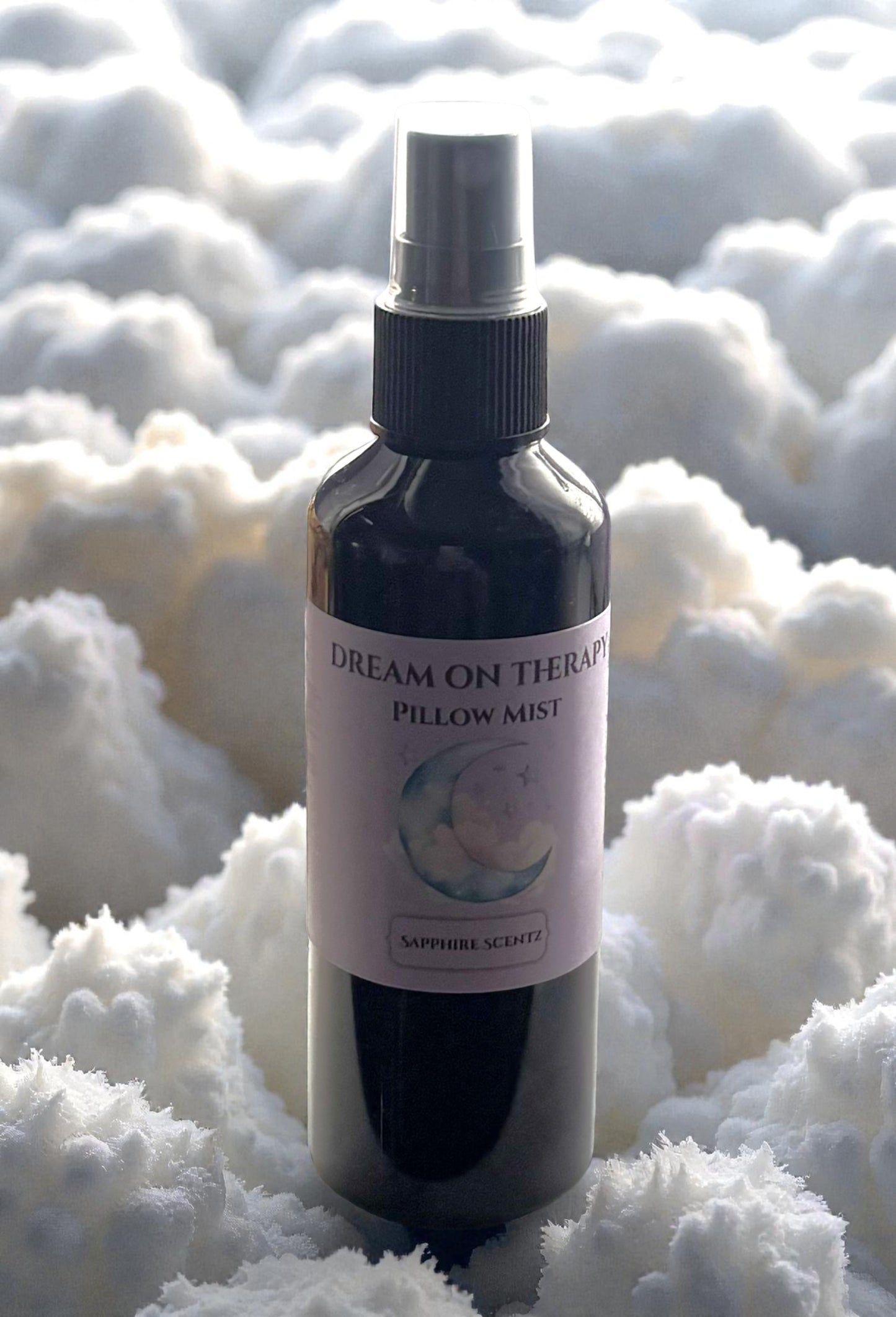Bottle of 'Dream on Therapy' pillow mist surrounded by fluffy white material