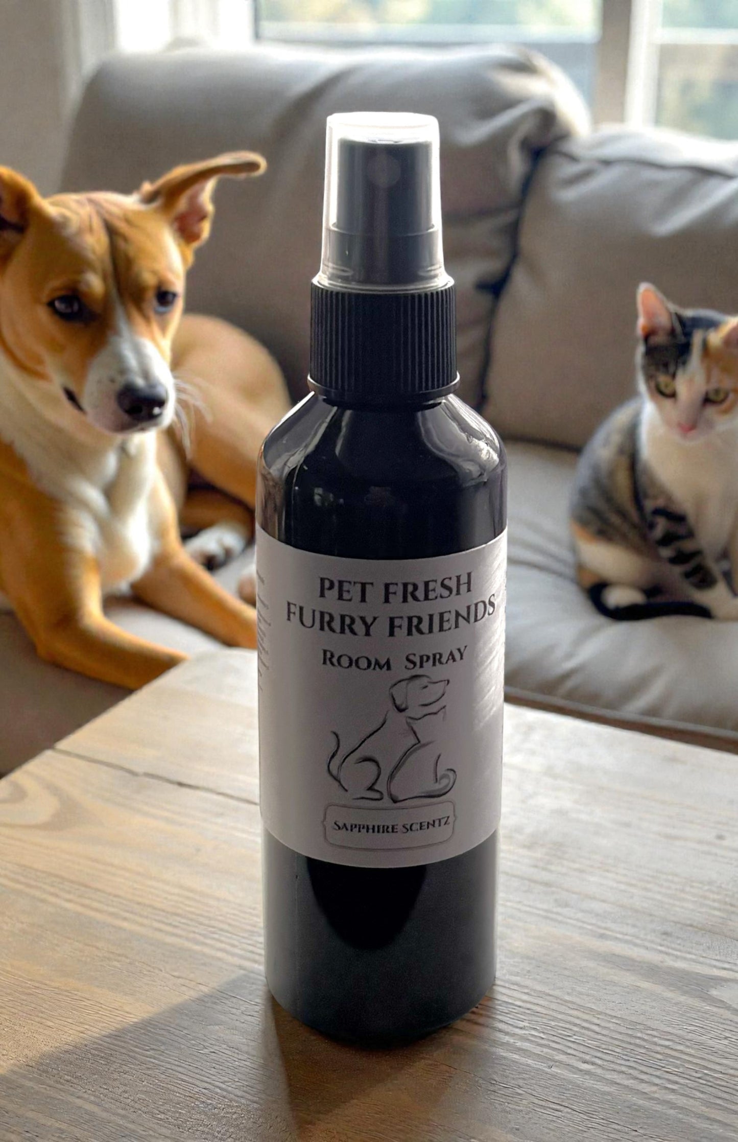 Pet Fresh Furry Friends room spray bottle on a table with a dog and cat in the background.