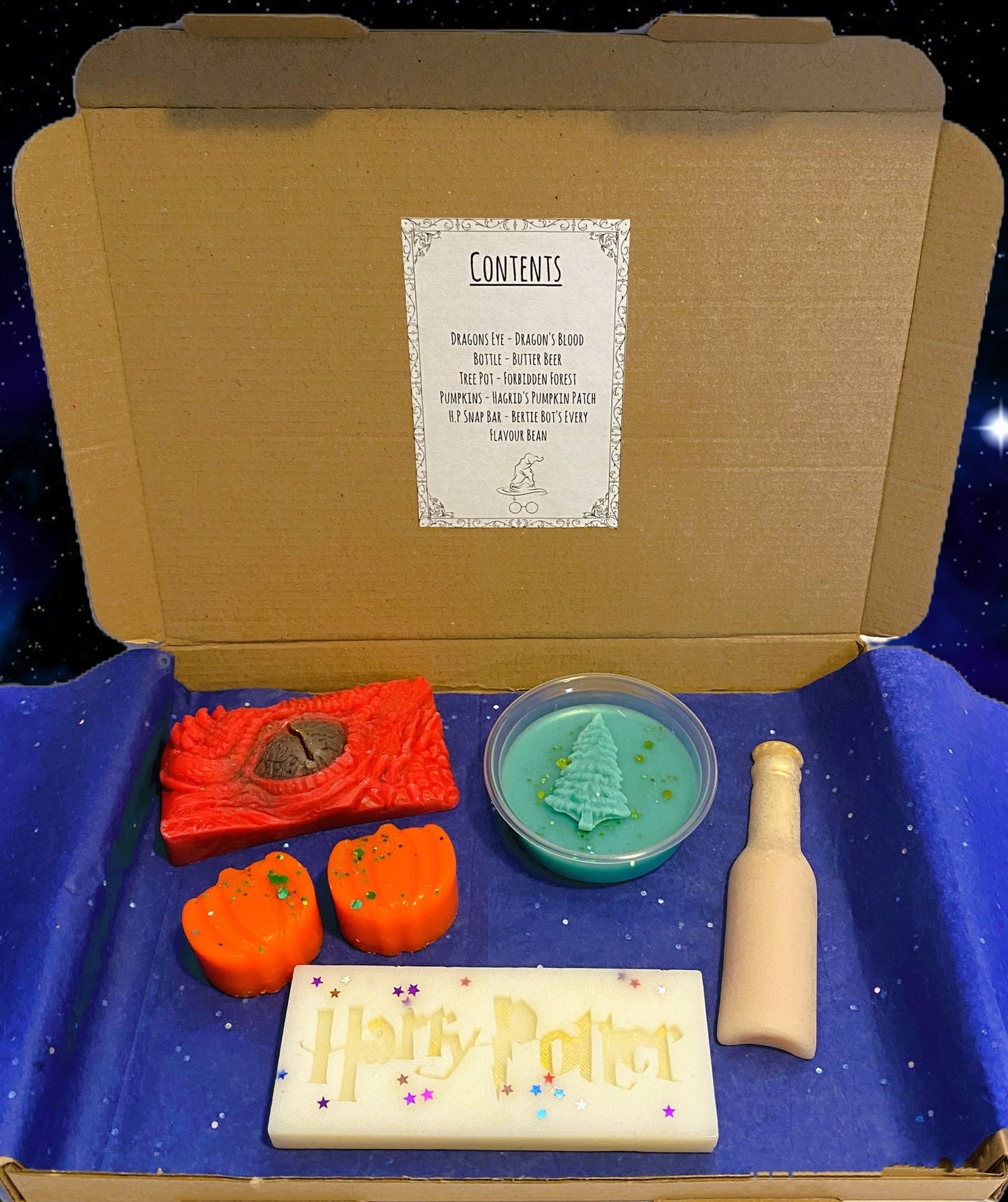 Harry Potter themed wax melts set, including various shapes and scents displayed in an open box.