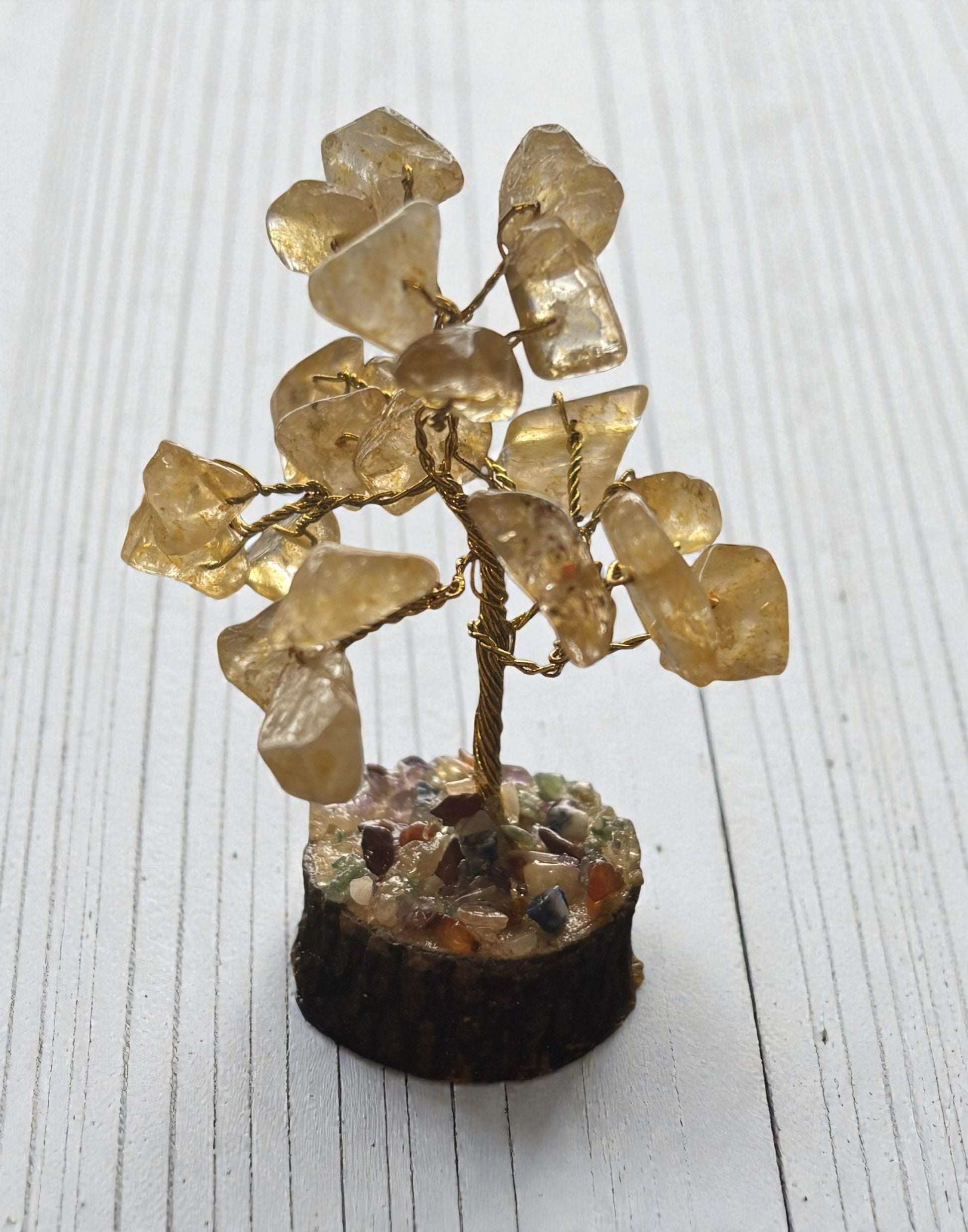 Crystal tree sculpture on a white wooden surface