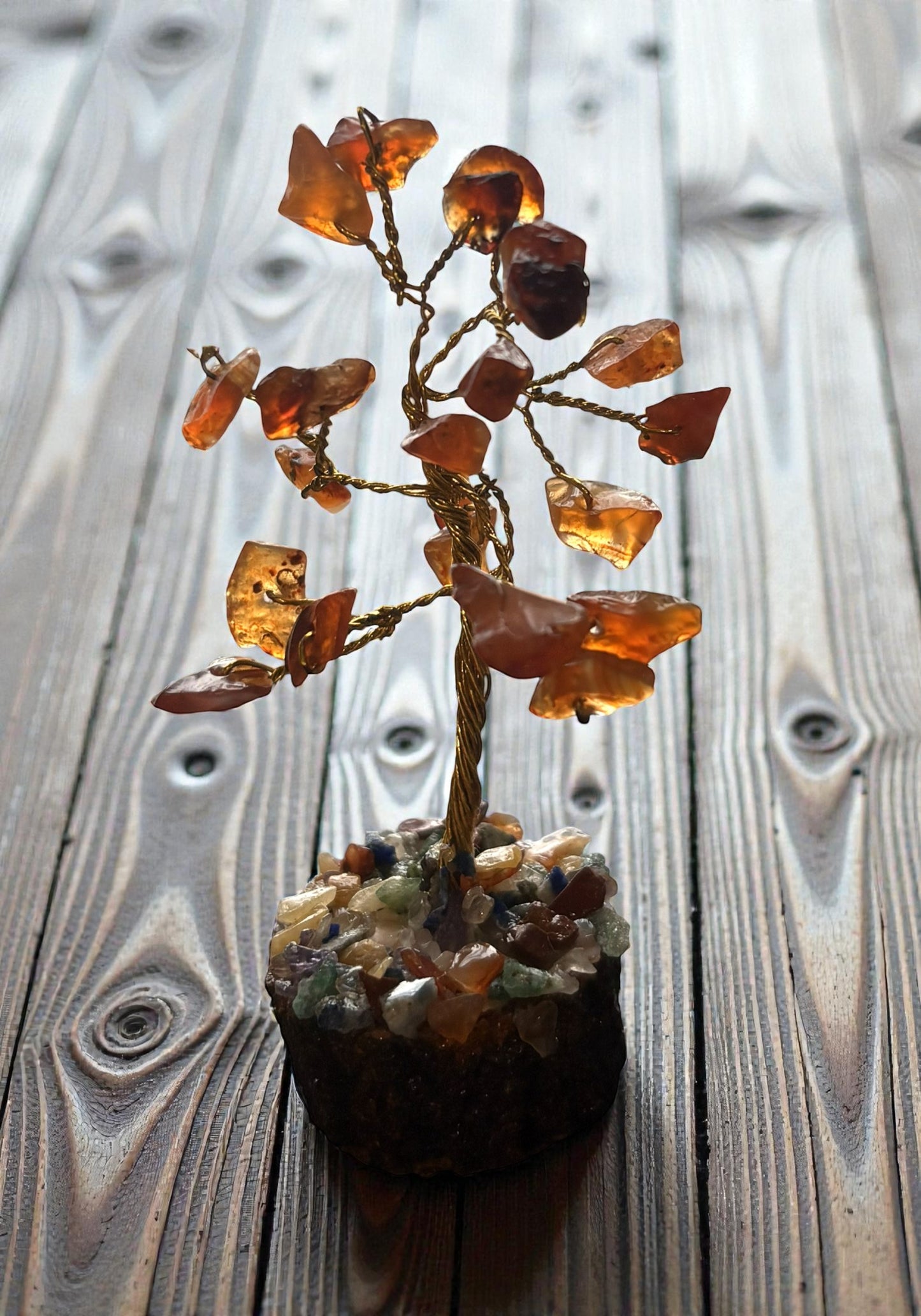 Mineral specimen with amber-like stones on a wooden surface