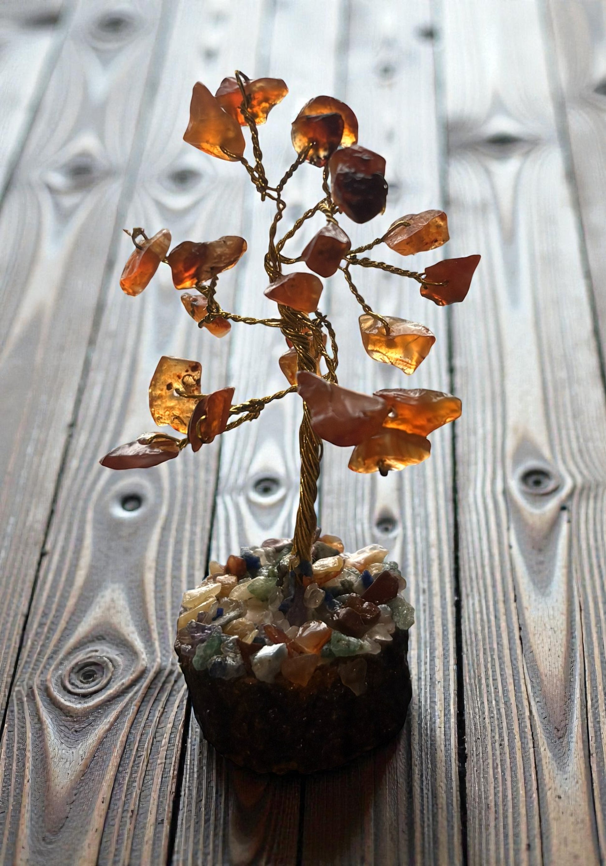 Mineral specimen with amber-like stones on a wooden surface