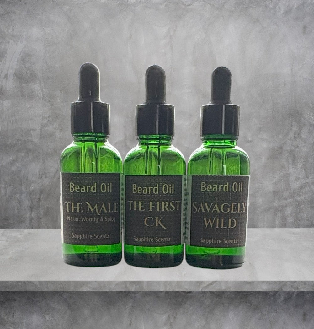 Three bottles of beard oil with droppers on a gray surface and background.