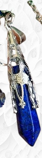 Blue crystal pendant with silver accents on a white background