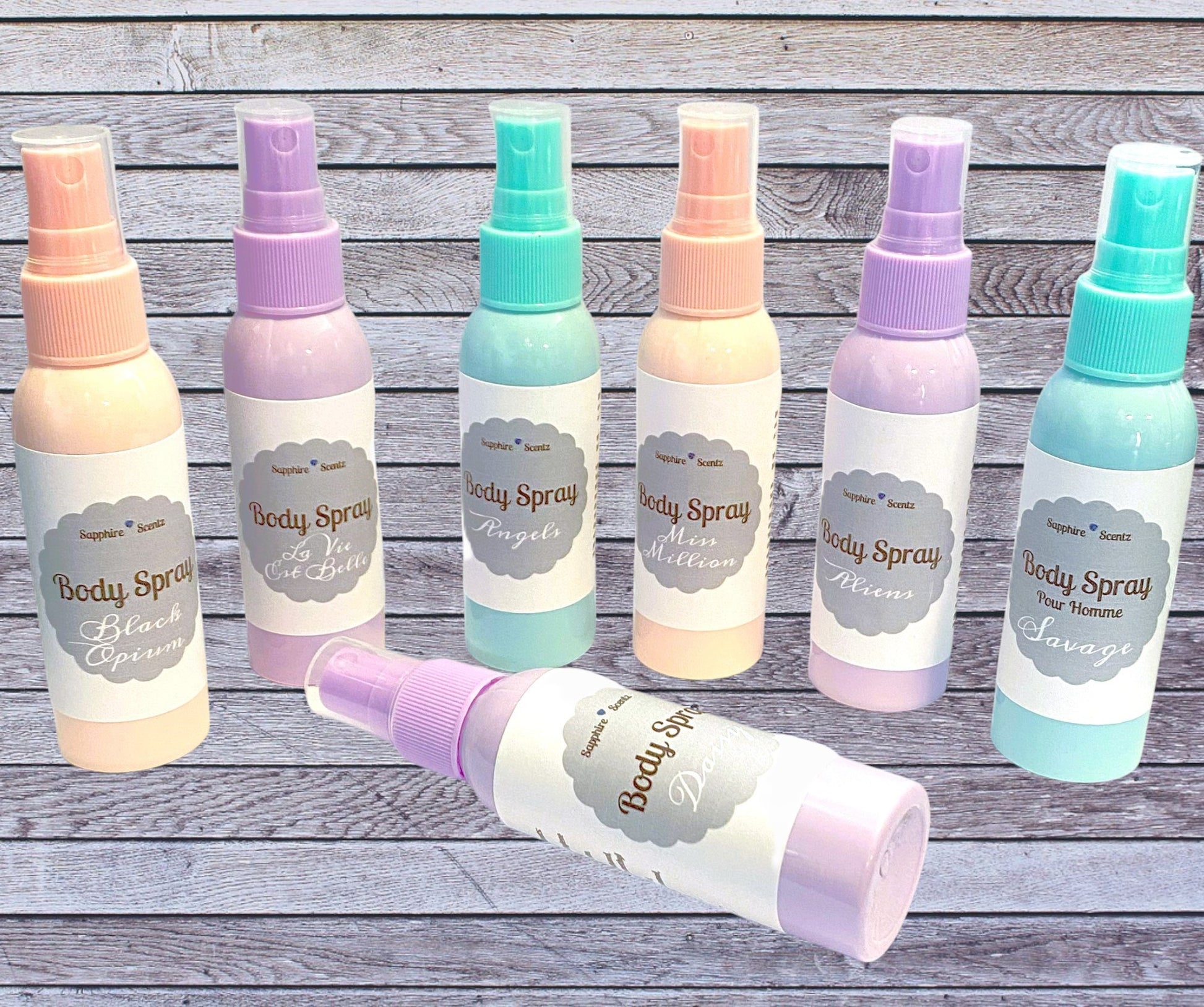 A collection of eight body spray bottles in various colors, labeled 'Body Spray' with a price tag in the background.