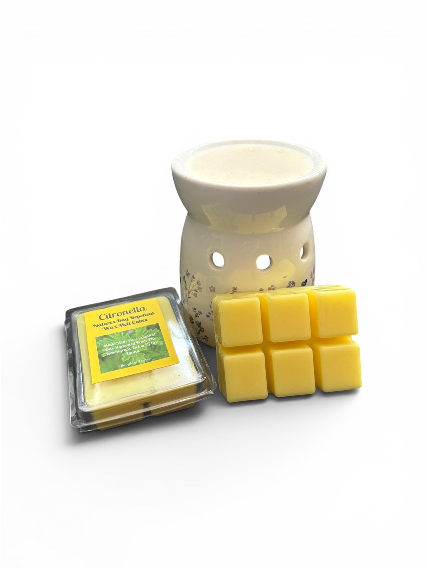 A wax melt set featuring a white ceramic wax warmer with floral detailing, a package of yellow wax melts labeled 'Citrusella', and nine yellow wax cubes arranged in a grid on a white background.