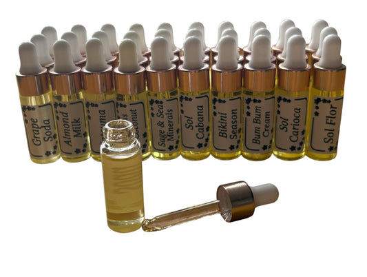 Collection of small glass bottles with droppers and labels on a white background