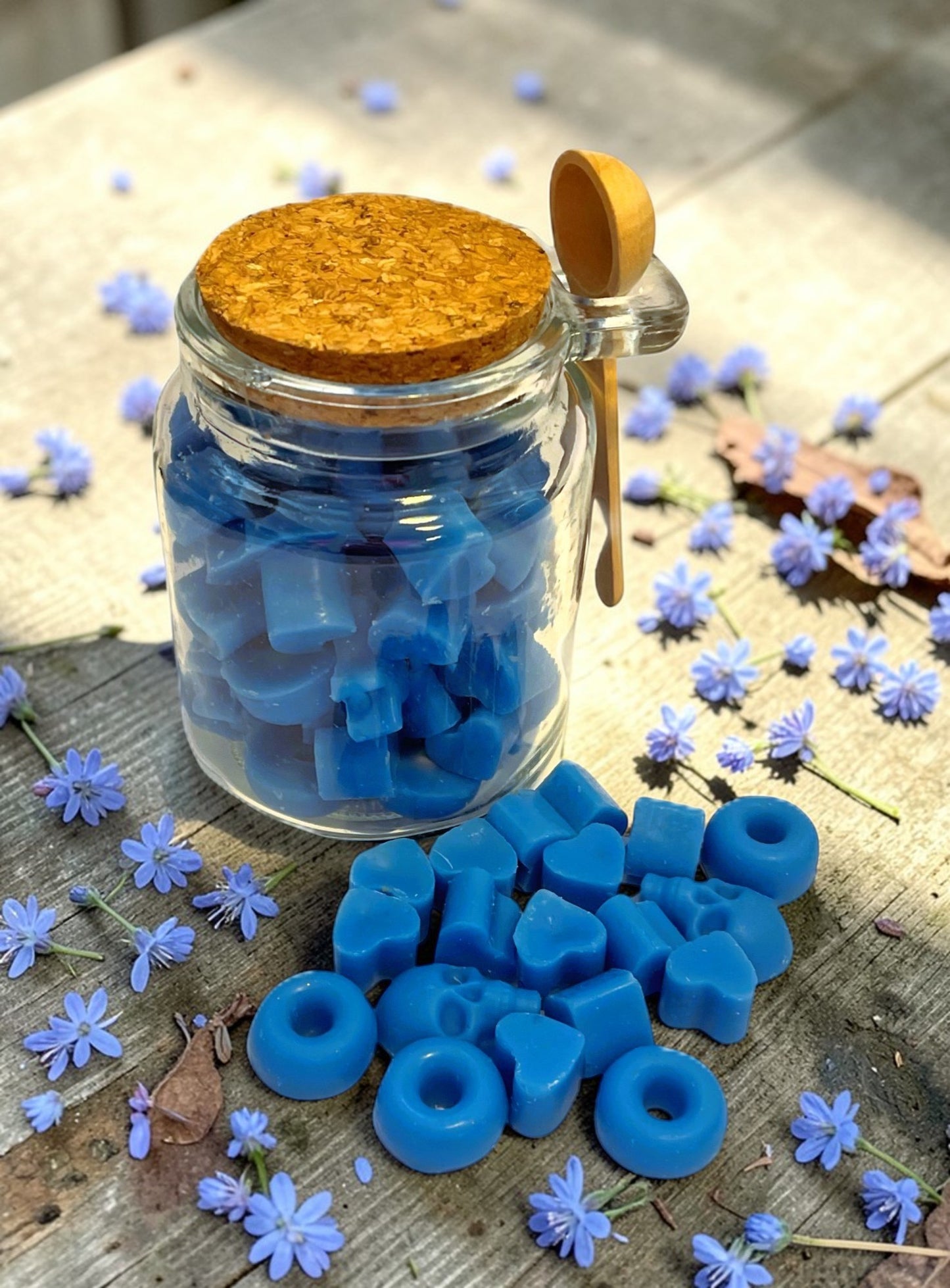 Jar of Blue mini wax melts with a cork lid and scoppie spoon