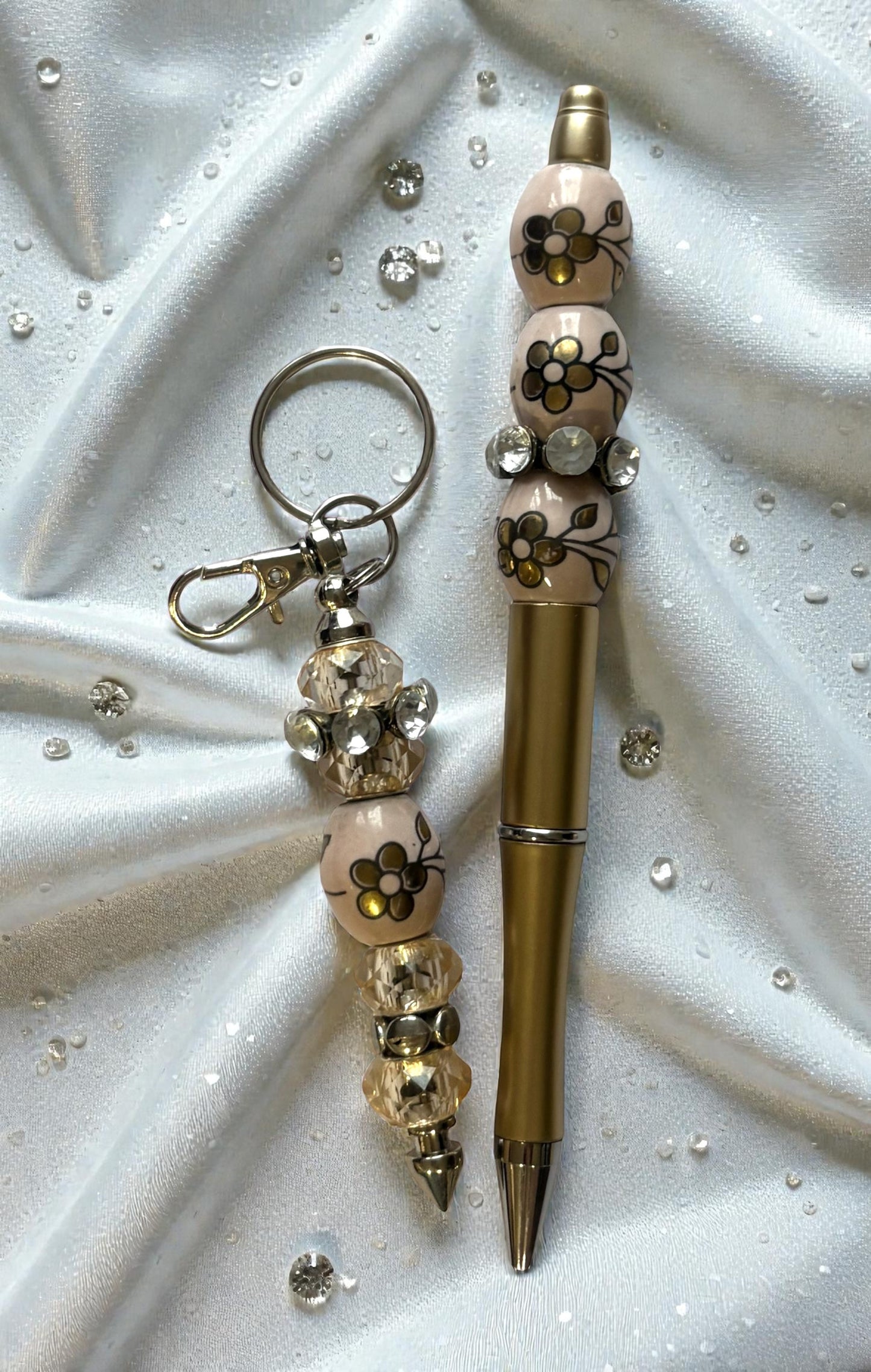 Decorative pen and keychain set on a textured white surface