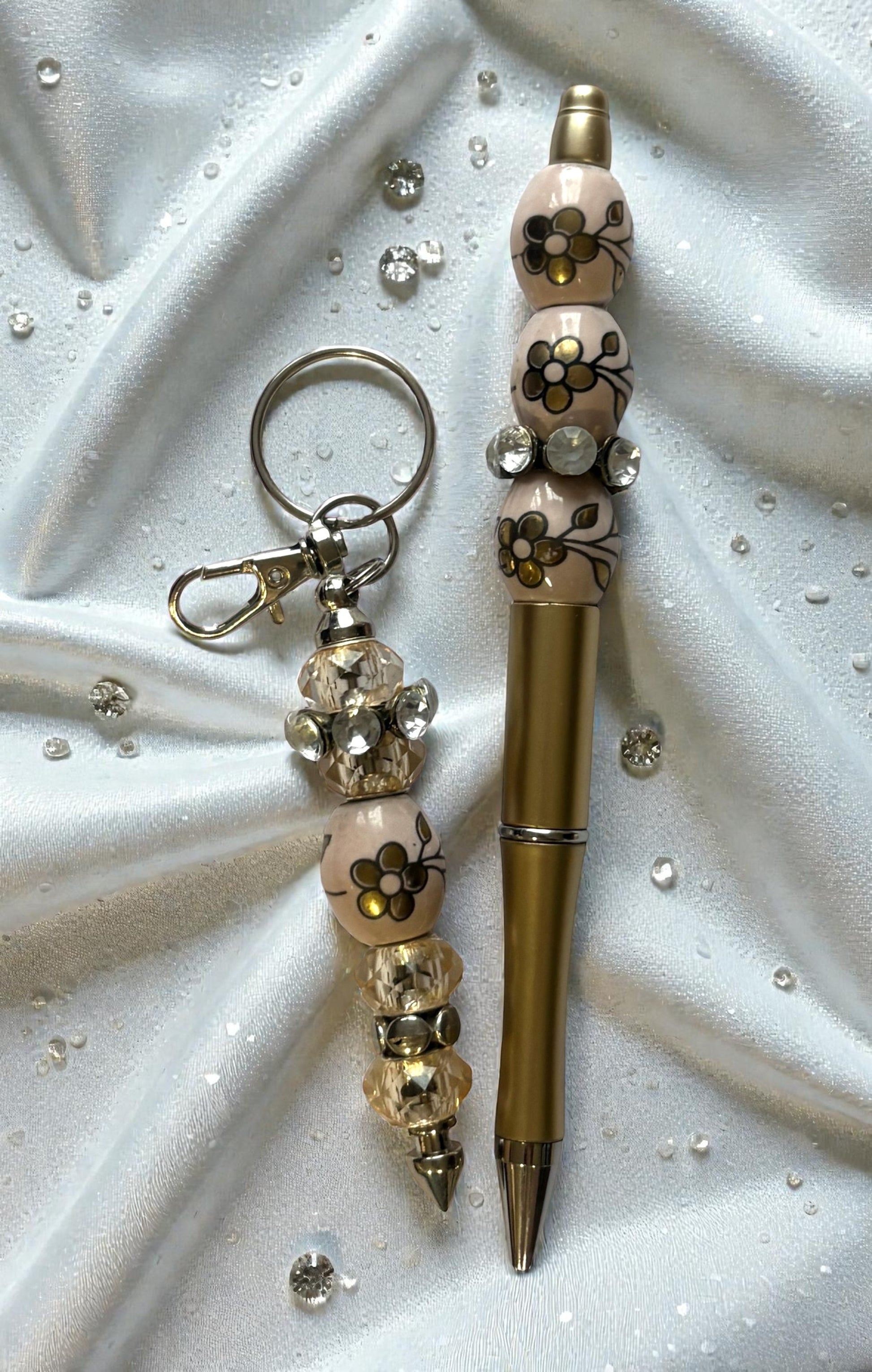 Decorative pen and keychain set on a textured white surface