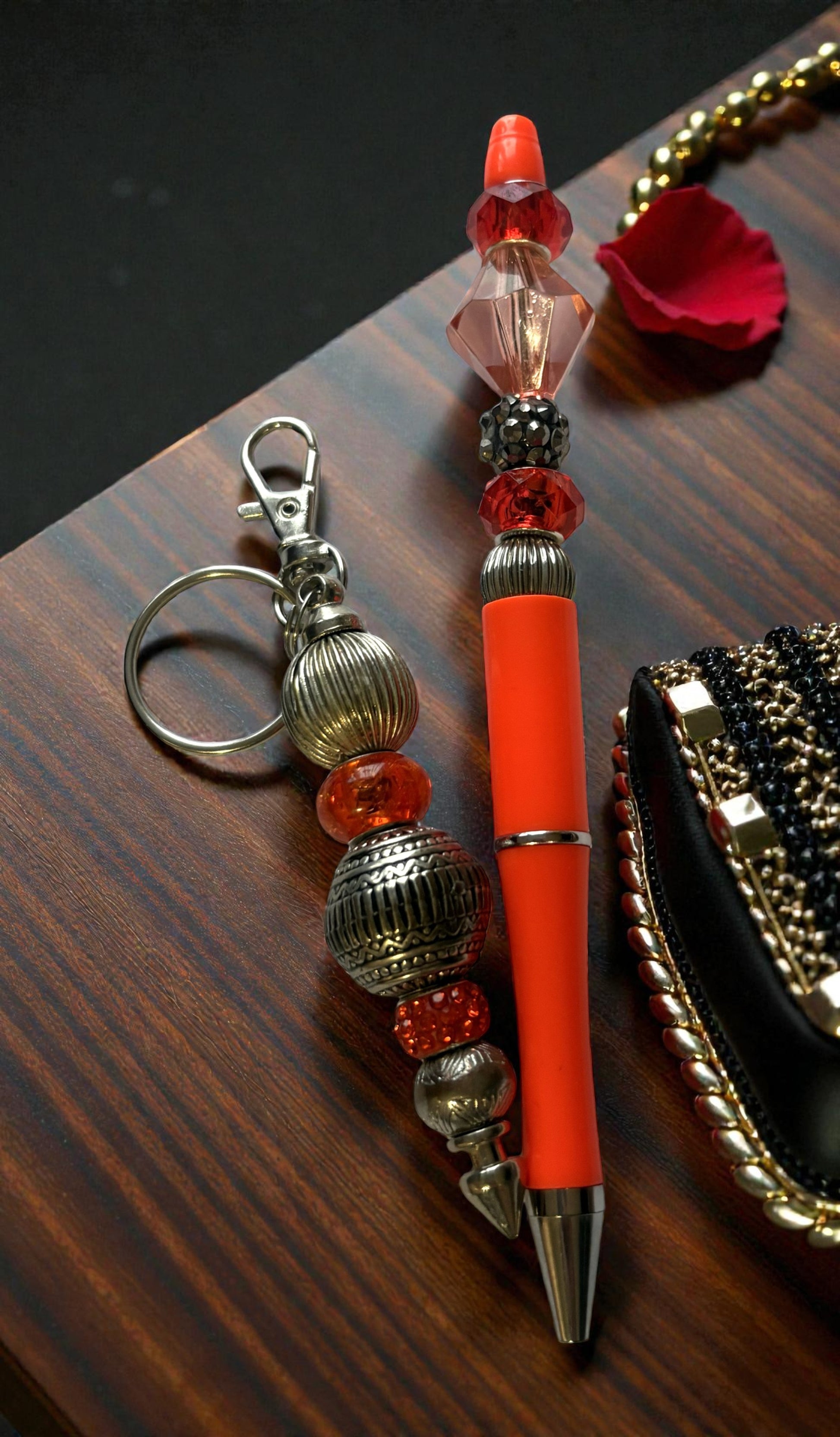 Decorative pen with beaded charm on a wooden surface