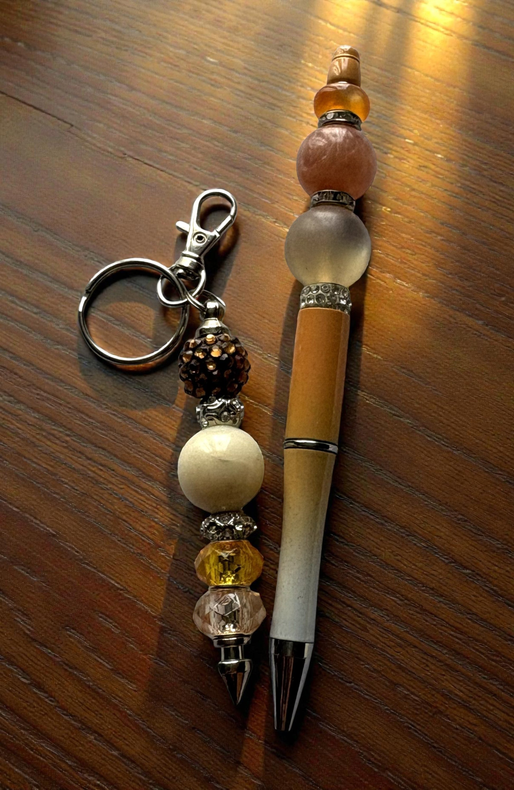 Beaded keychain and pen on a wooden surface