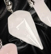 Close-up of a white pendant with a black background