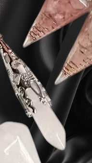 Close-up of decorative earrings with intricate designs on a dark background