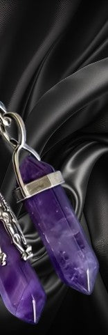 Purple crystal keychain on a black satin background