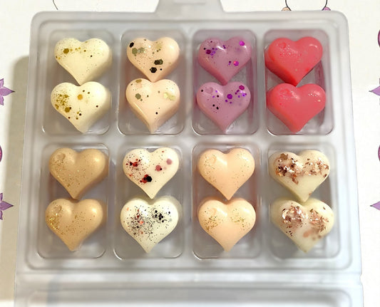 Heart-shaped candies in a clear plastic mold on a white background