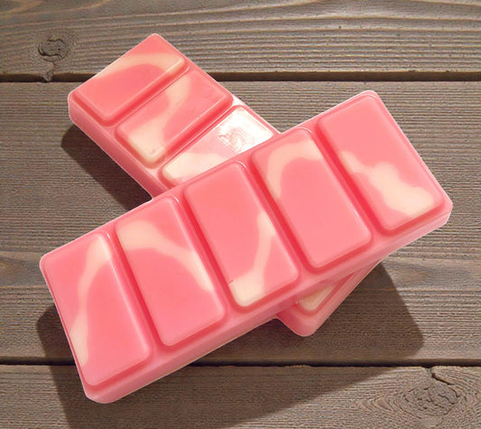 Pink silicone mold for making lip balm on a wooden surface