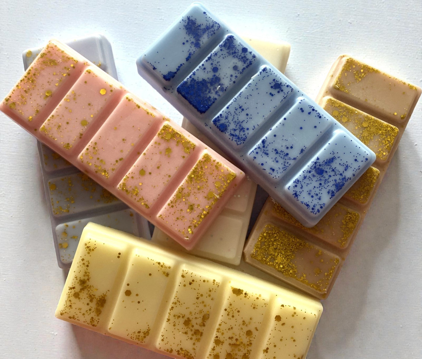 Assorted soap bars with different colors and textures on a white background