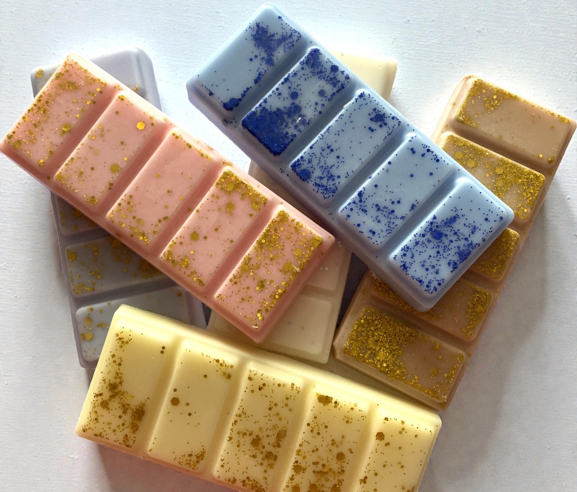 Assorted soap bars with different colors and textures on a white background