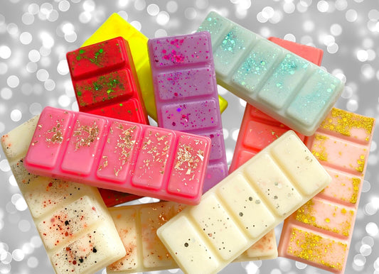 A collection of colorful snap bars with a glittery appearance, each bar is sectioned into five parts. The bars are in various colors including red, pink, blue, green, and white.